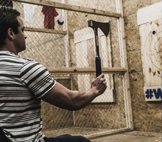 A guy prepared to throw an axe